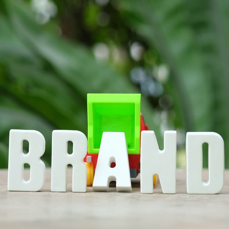 Hand arrange white letters BRAND