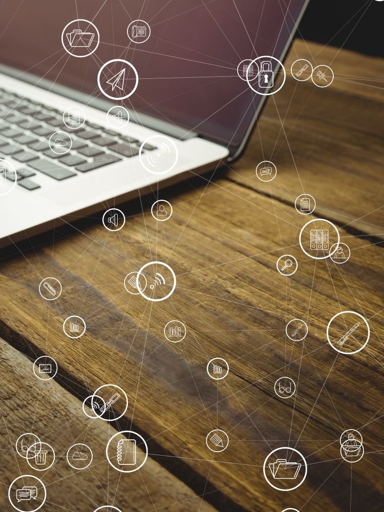digital composite of laptop with communication graphics