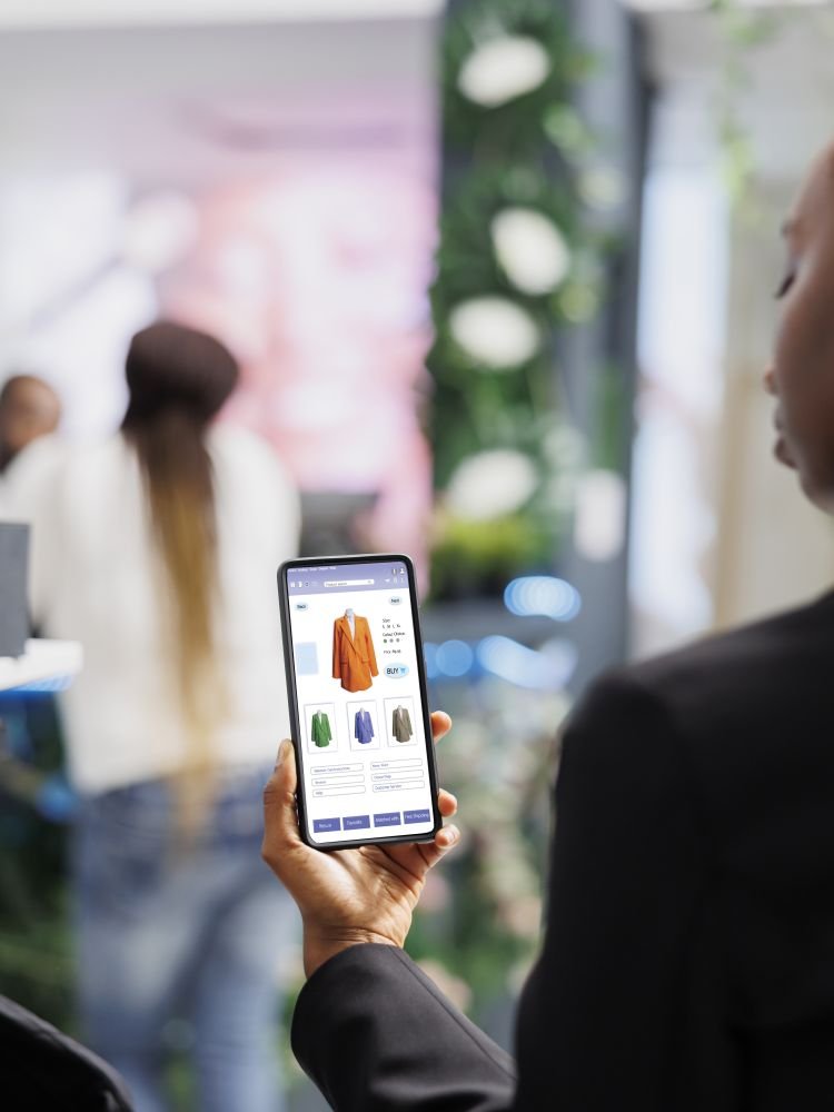 Shopper using online store mobile app on phone, examining modern fashion items collection and buying merchandise. Boutique client looking at clothing line on retail shop website.
